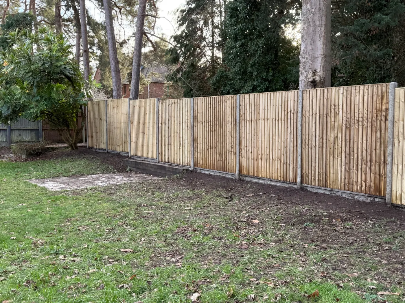 Long closeboard boundary fence installed in a large Surrey garden