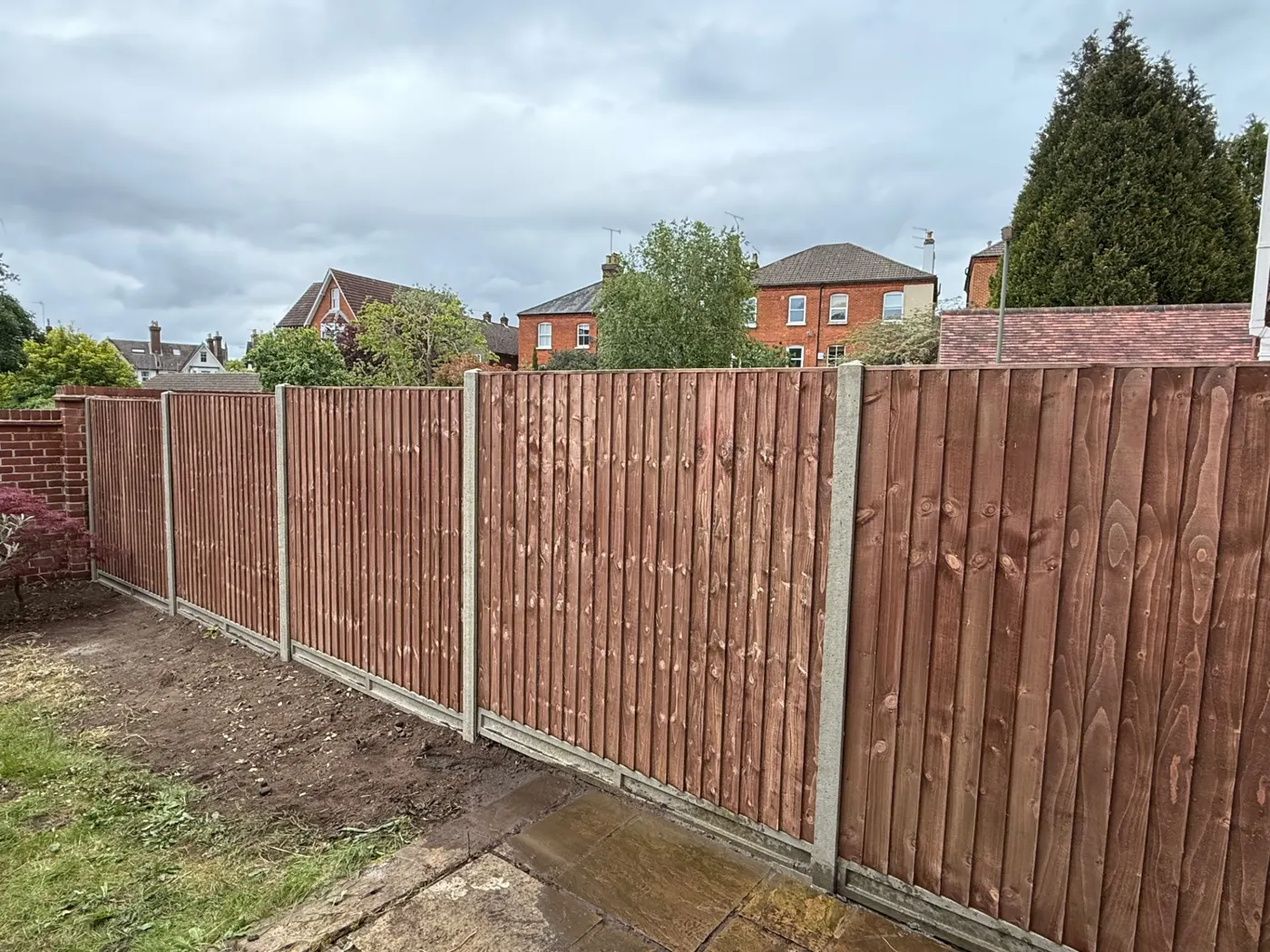 Feather edge fencing with concrete posts and gravel boards in Surrey