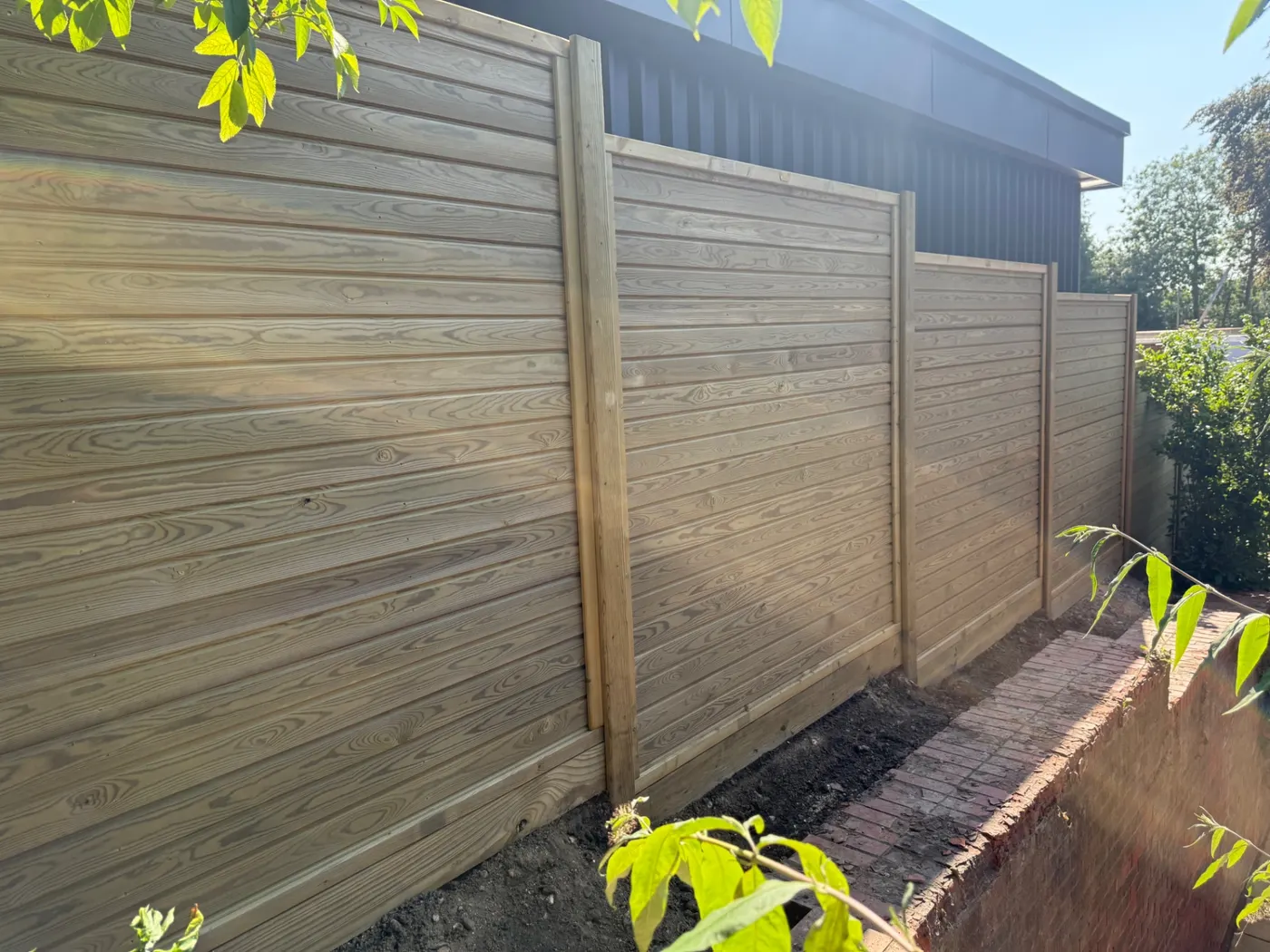 Horizontal tongue and groove fence panels installed in a Surrey garden