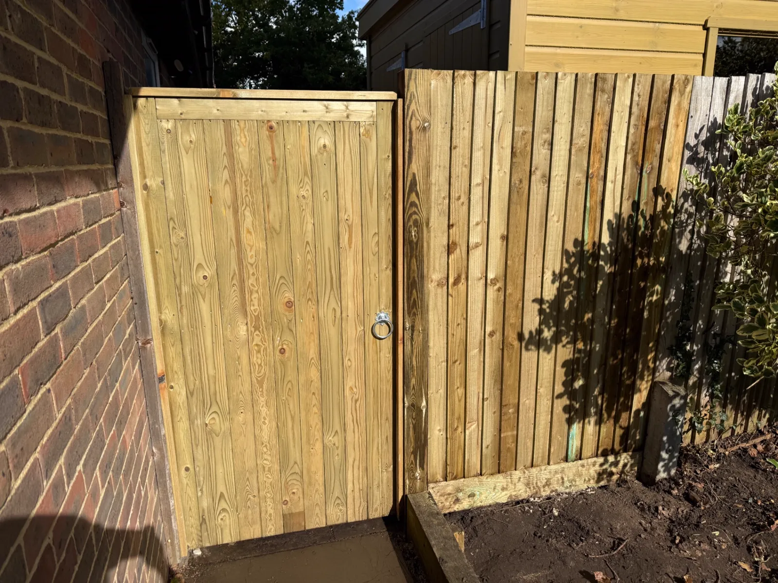 New tongue and groove side gate fitted beside a house in Surrey
