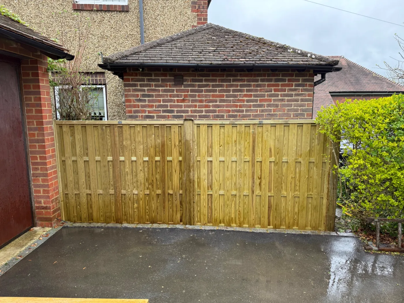 Tongue and groove garden fence panels screening a driveway in Surrey