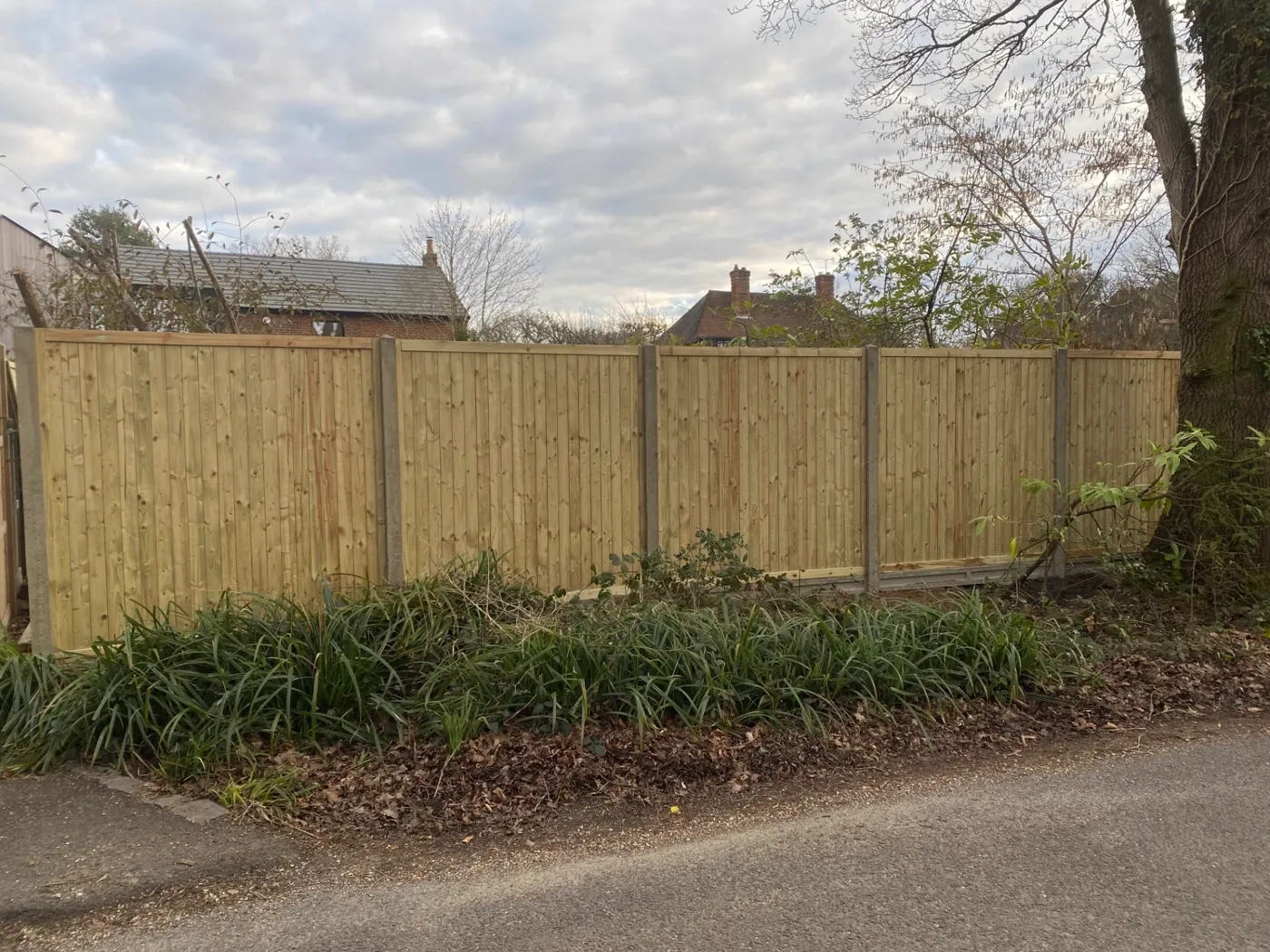 Feather edge garden fence panels facing a village lane in Surrey